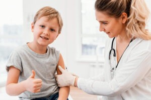 close up of child getting his immunization and smiling